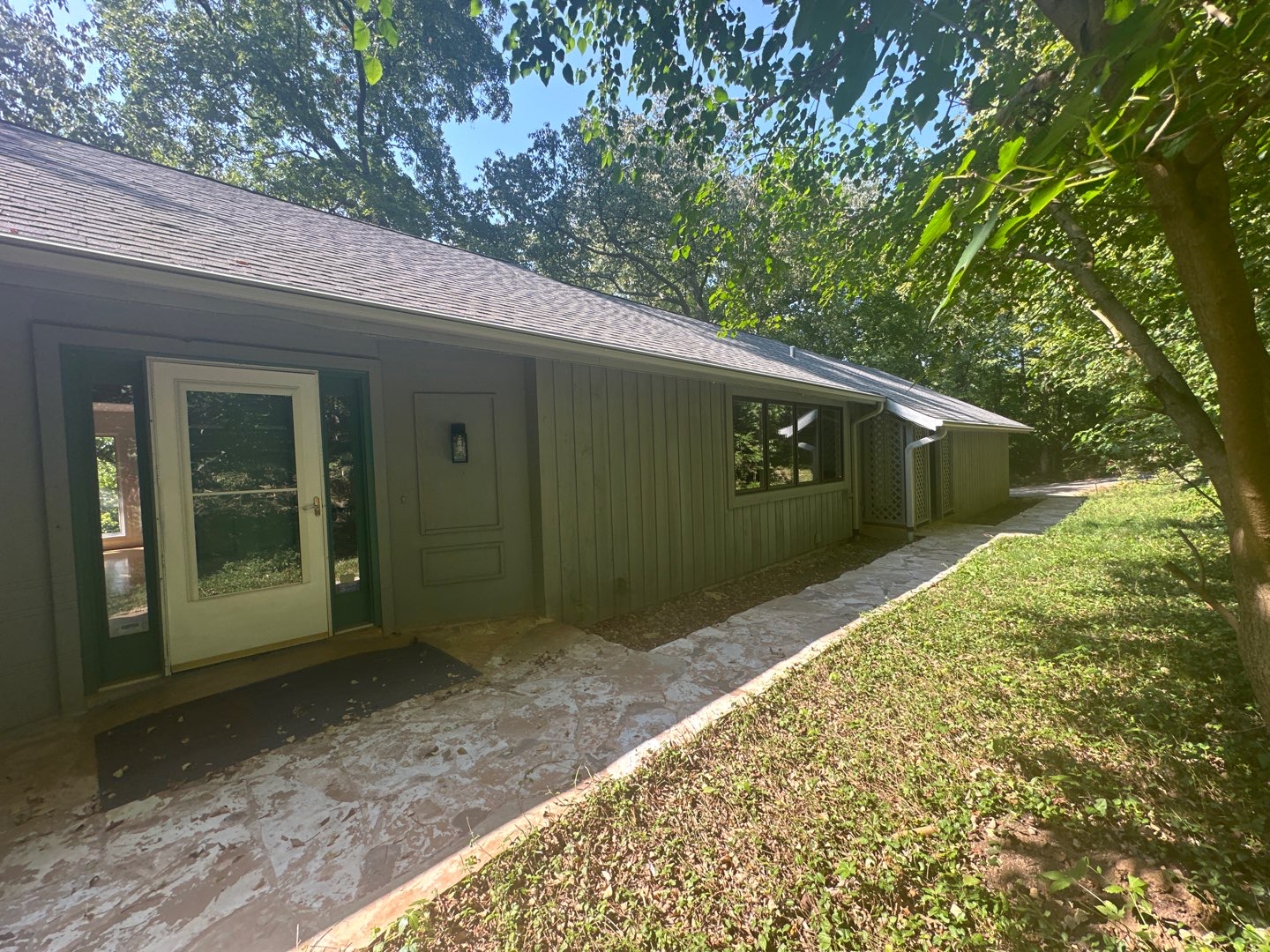 Kirkwood home with freshly cleaned siding under mature trees