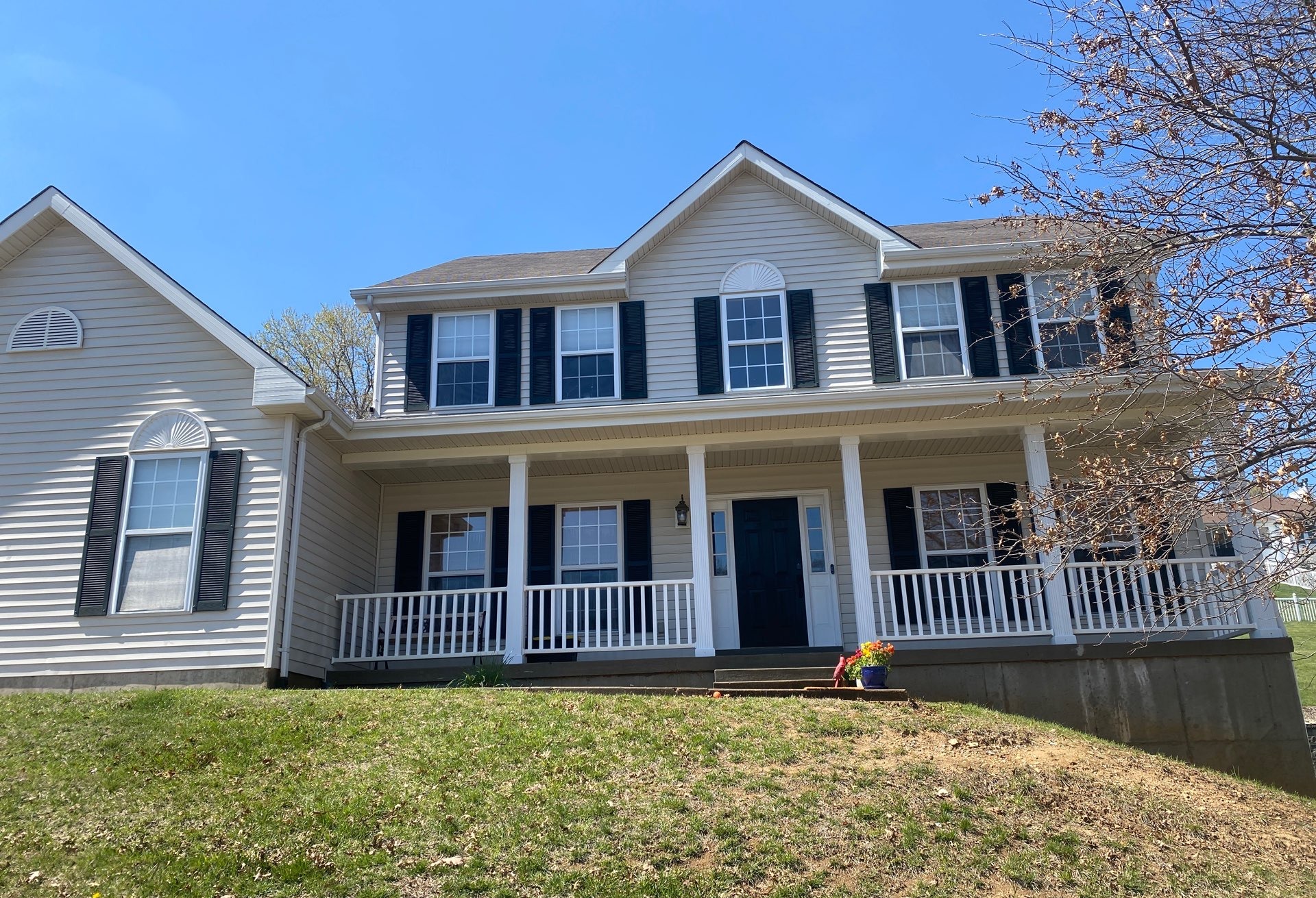 Two-story Fenton home with clean white vinyl siding